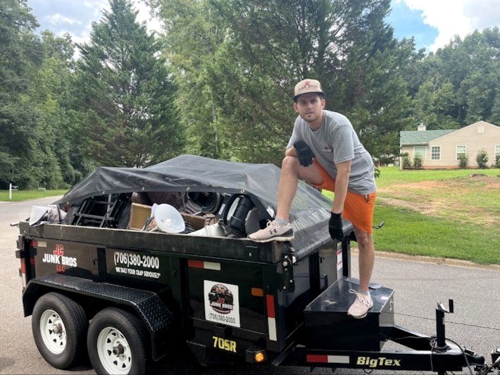 JC Junk Bros crew with a loaded junk removal trailer